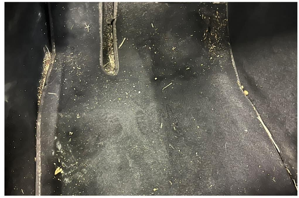 Tesla driver floor when received showing fading and foreign material